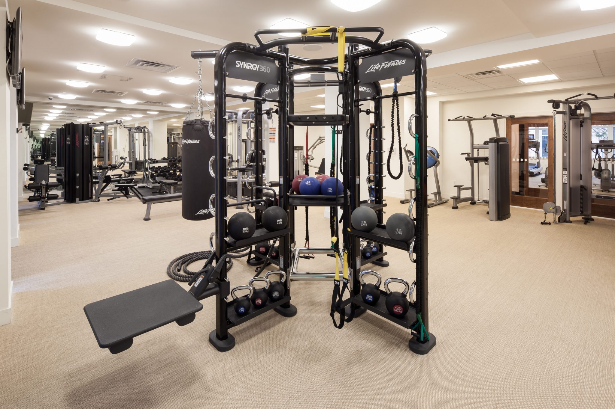 Interior of fitness center with free weights and other exercise machines.