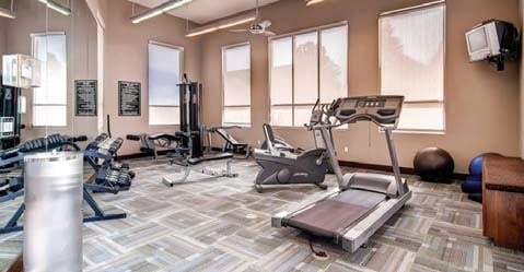 Fitness center with various exercise equipment.
