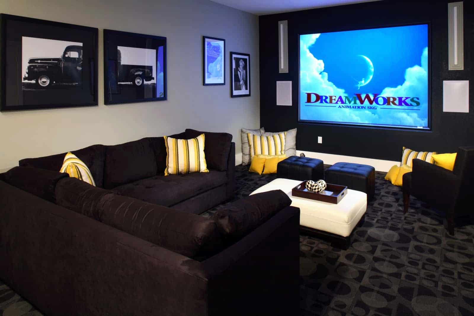 Theatre room with couches, and ottomans.