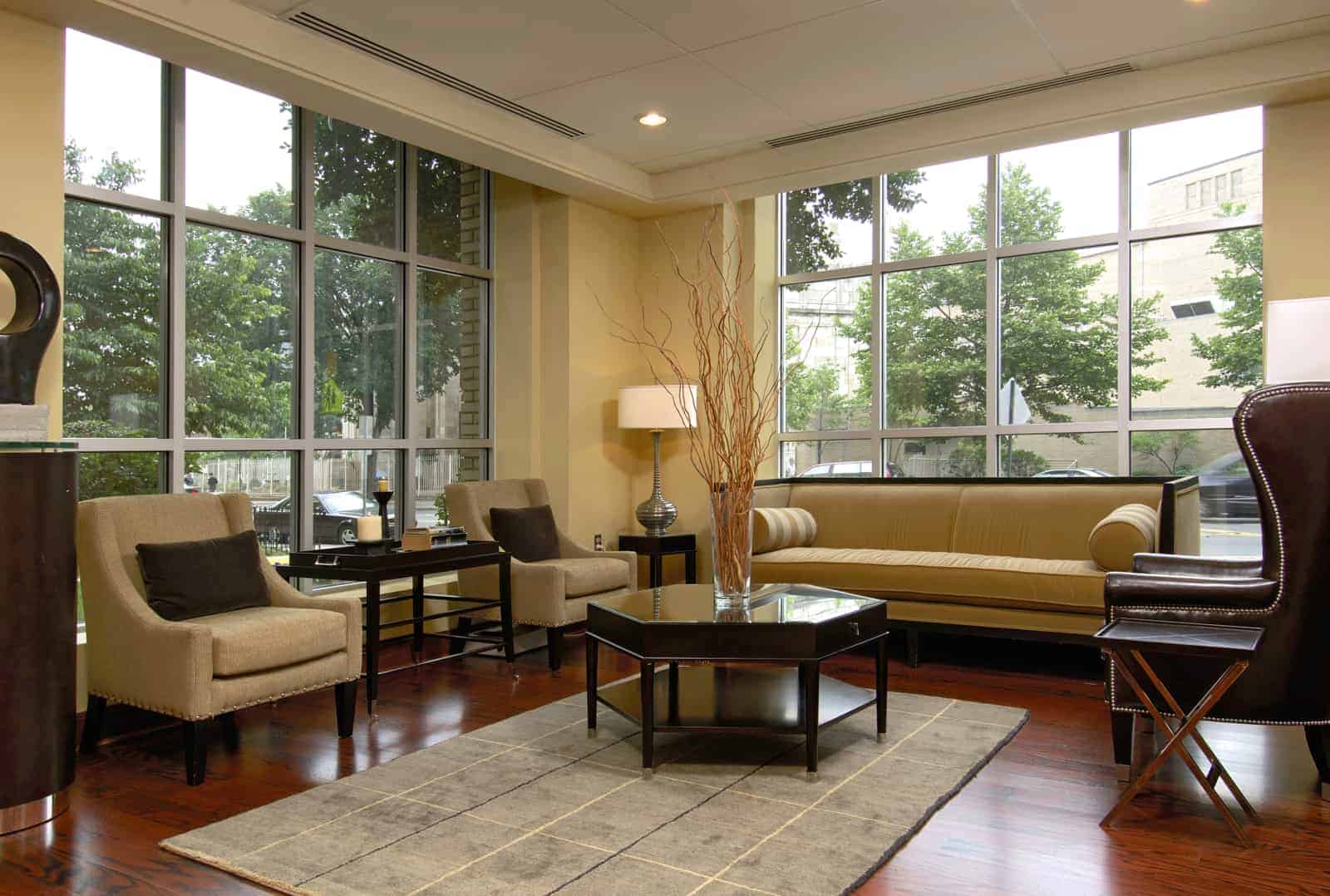 Interior of lobby with couch, chairs, coffee table, side tables, and lamps.
